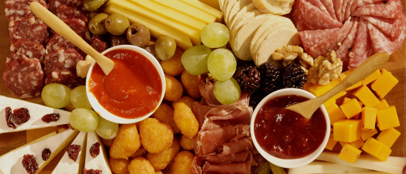 Overhead photo of the Game Day Char-curd-erie Board on an orange background.
